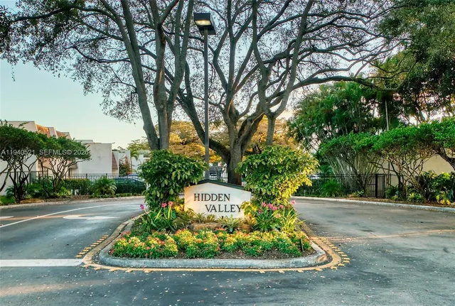 a view of a street with a large trees