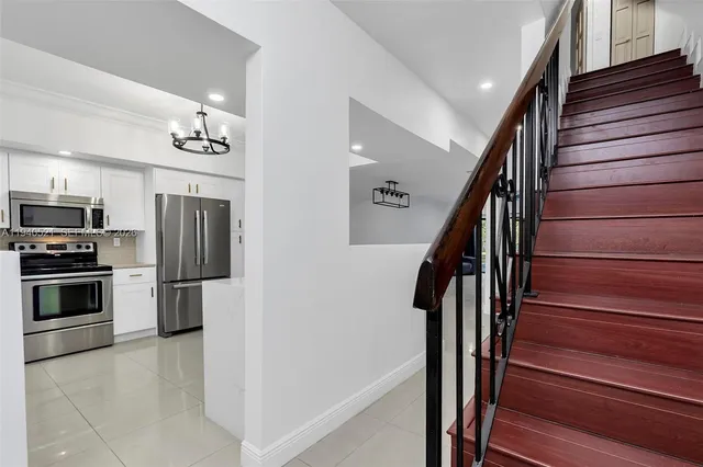 a spacious bathroom with a granite countertop sink a mirror and shower