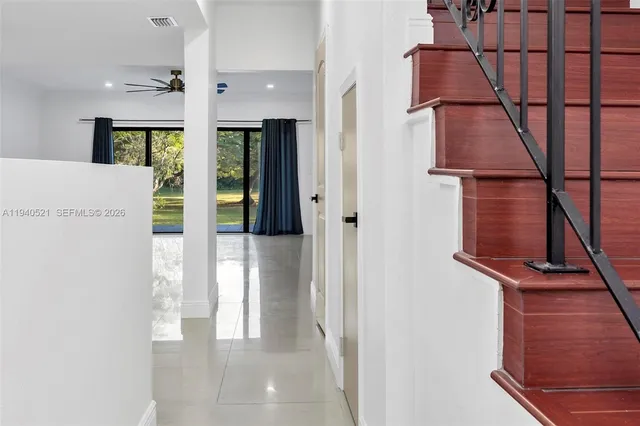 a kitchen with granite countertop a sink stainless steel appliances and cabinets