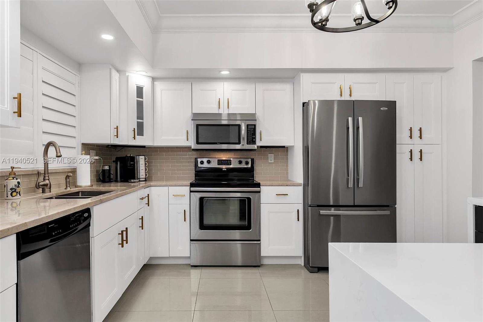 8898 Southwest 62nd Terrace, Unit 7F Miami, FL 33173 - Photo 14 of 66 a kitchen with stainless steel appliances a refrigerator sink and microwave