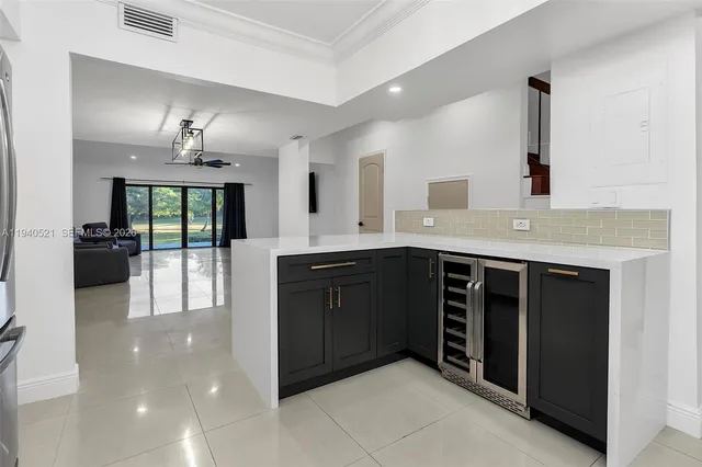 a living room with furniture and a walk in closet with wooden floor