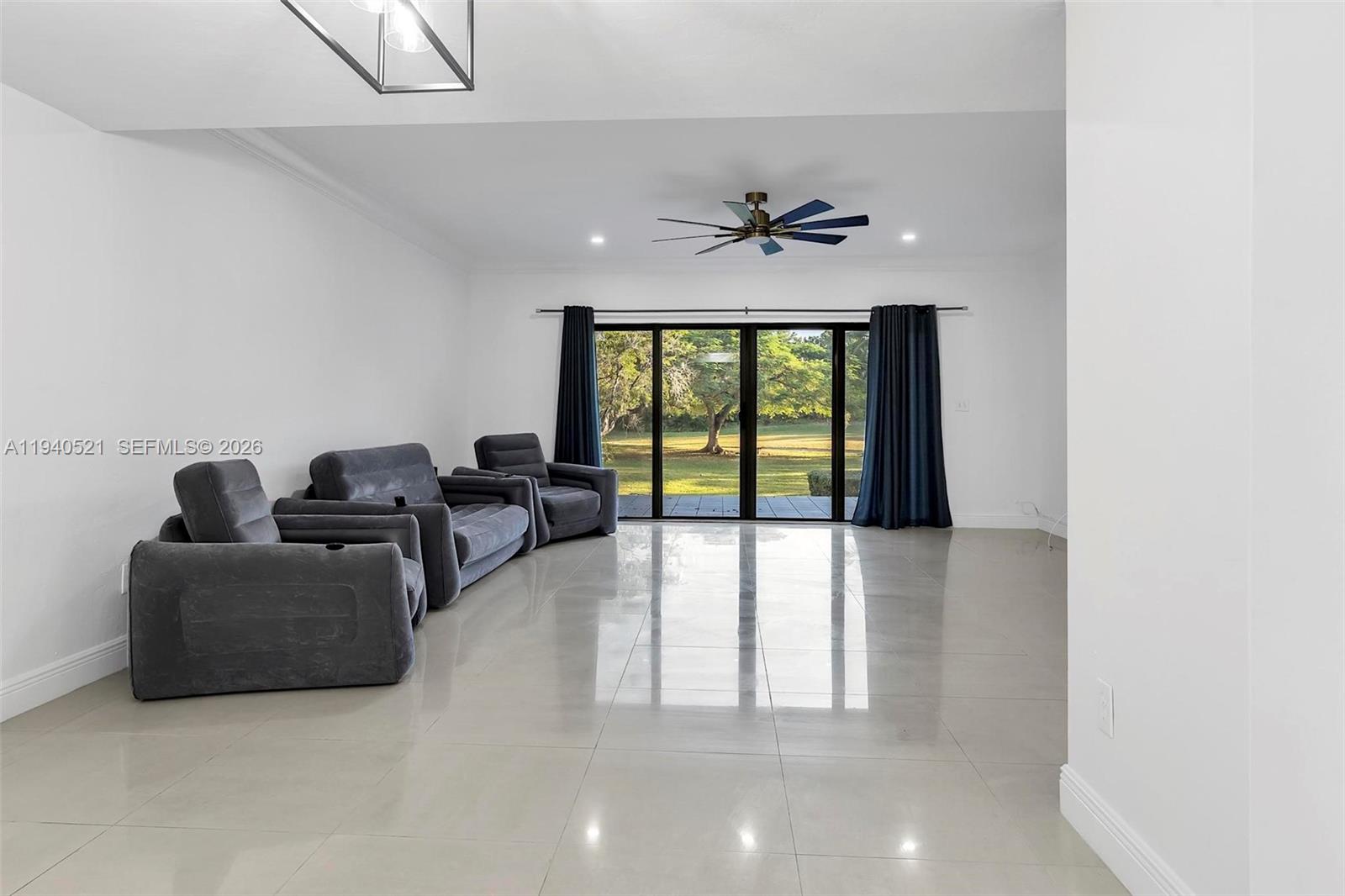 8898 Southwest 62nd Terrace, Unit 7F Miami, FL 33173 - Photo 26 of 66 a living room with furniture and a large window