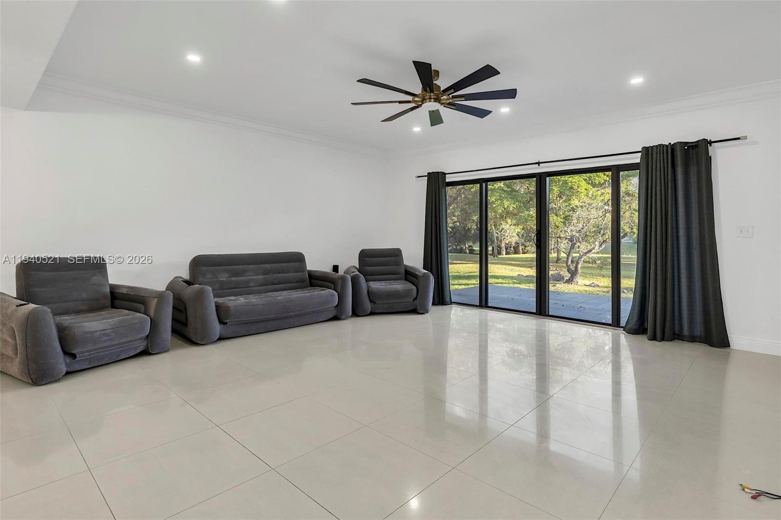 8898 Southwest 62nd Terrace, Unit 7F Miami, FL 33173 - Photo 28 of 66 a living room with furniture and a large window