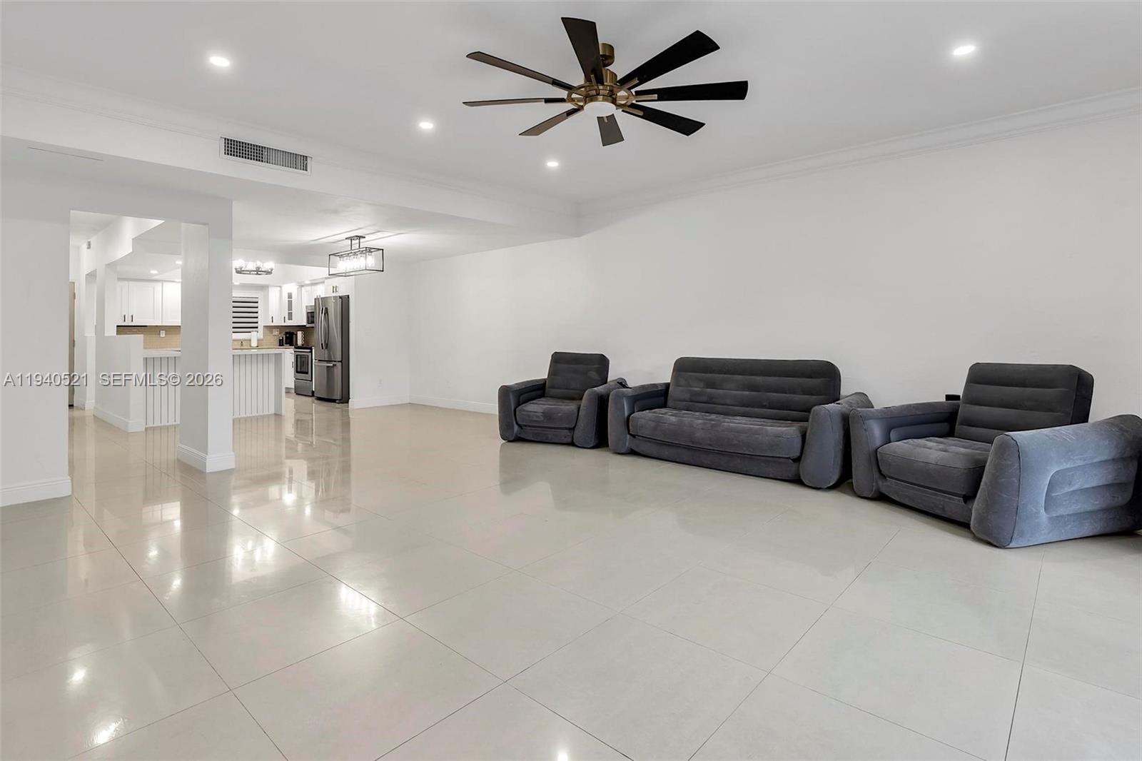 8898 Southwest 62nd Terrace, Unit 7F Miami, FL 33173 - Photo 34 of 66 a living room with furniture and a ceiling fan