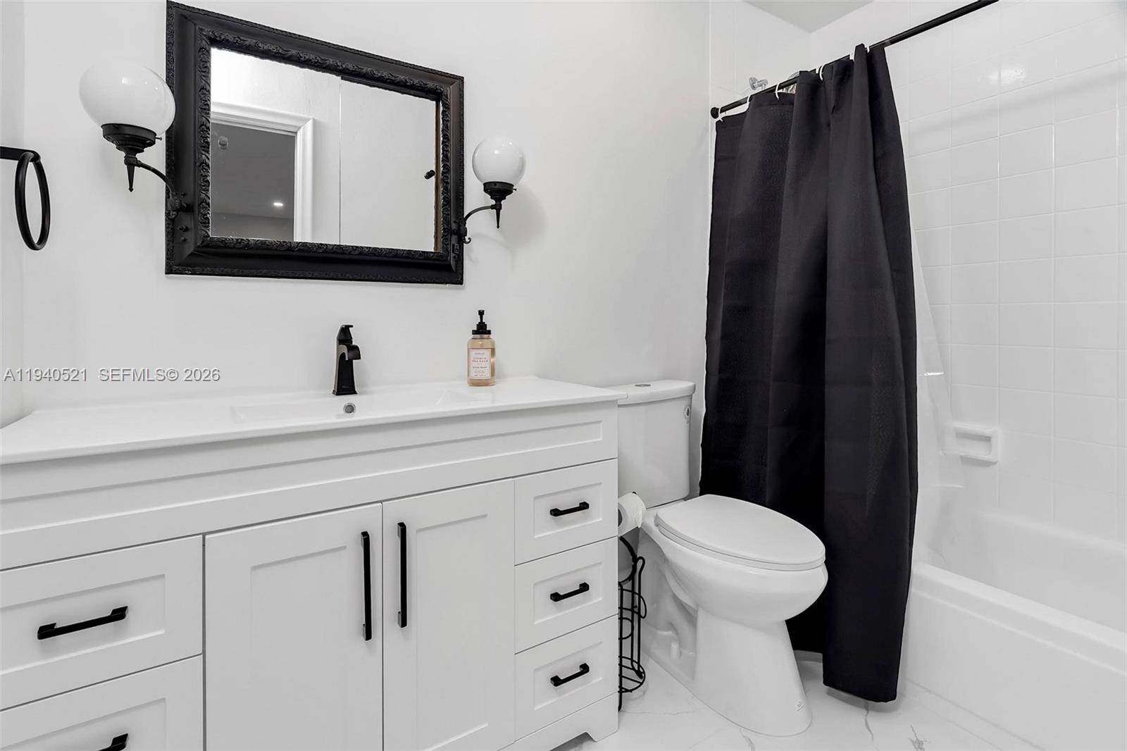 8898 Southwest 62nd Terrace, Unit 7F Miami, FL 33173 - Photo 44 of 66 a bathroom with a toilet sink and mirror