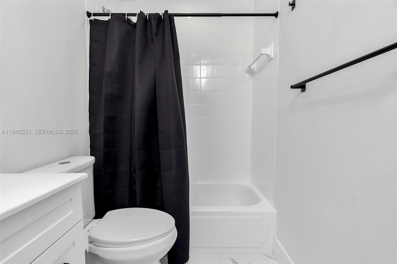 8898 Southwest 62nd Terrace, Unit 7F Miami, FL 33173 - Photo 45 of 66 a bathroom with a shower a toilet and sink