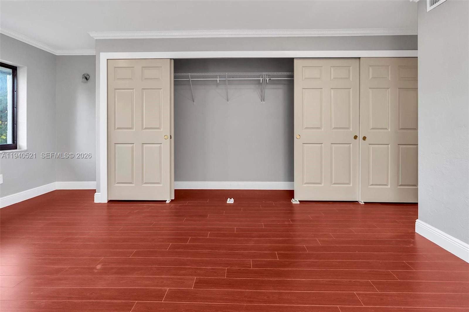 8898 Southwest 62nd Terrace, Unit 7F Miami, FL 33173 - Photo 57 of 66 a view of an empty room with wooden floor