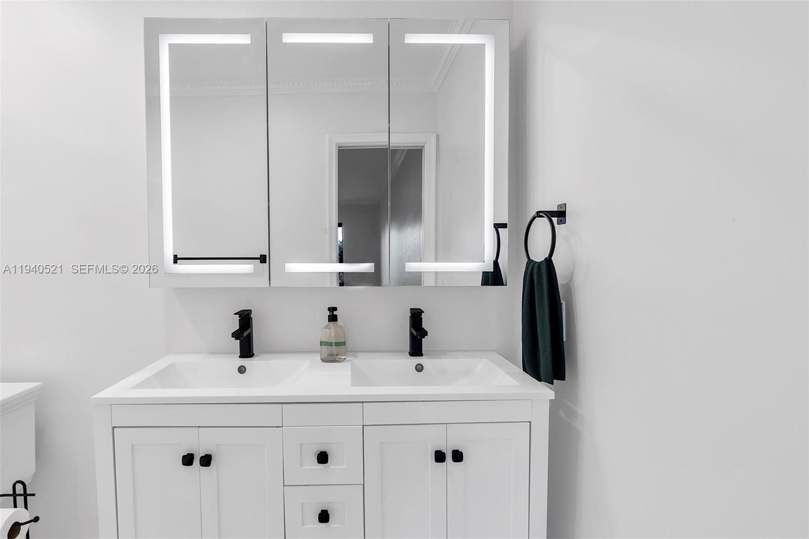 8898 Southwest 62nd Terrace, Unit 7F Miami, FL 33173 - Photo 58 of 66 a bathroom with a sink and a mirror