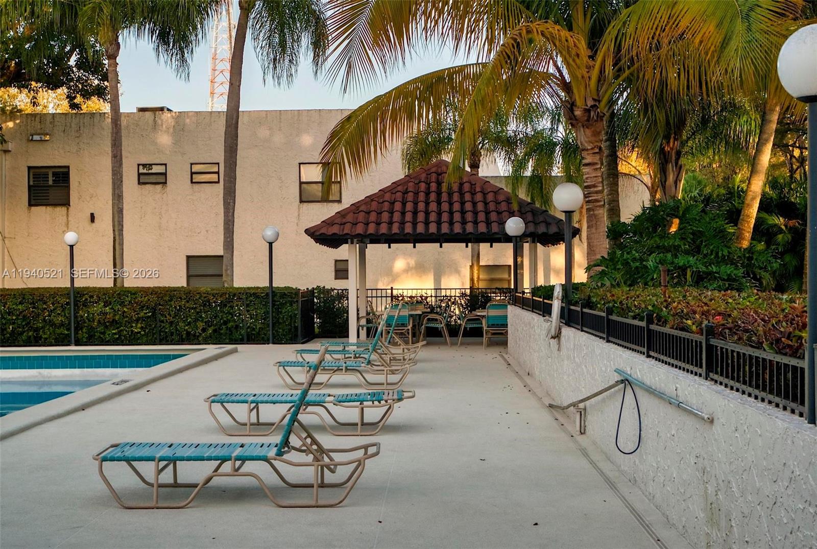8898 Southwest 62nd Terrace, Unit 7F Miami, FL 33173 - Photo 65 of 66 a view of a swimming pool with chairs