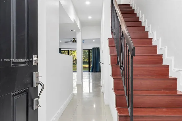 a kitchen with stainless steel appliances a refrigerator sink and microwave