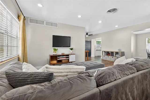 a bedroom with furniture and a flat screen tv