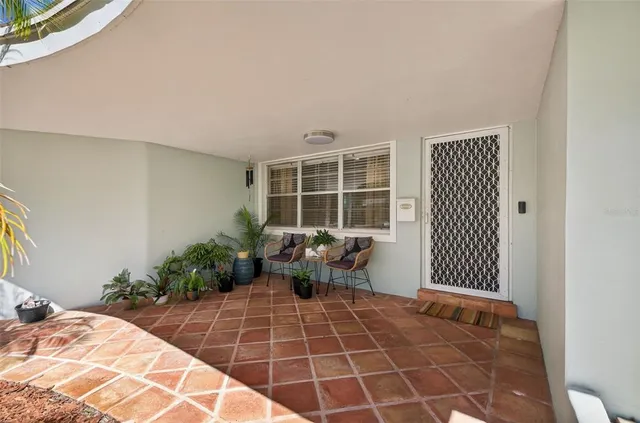 a balcony with couch and potted plant