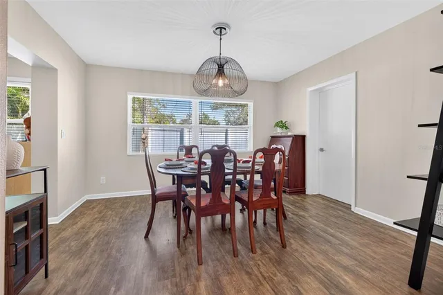 a view of a dining room with furniture window and wooden floor