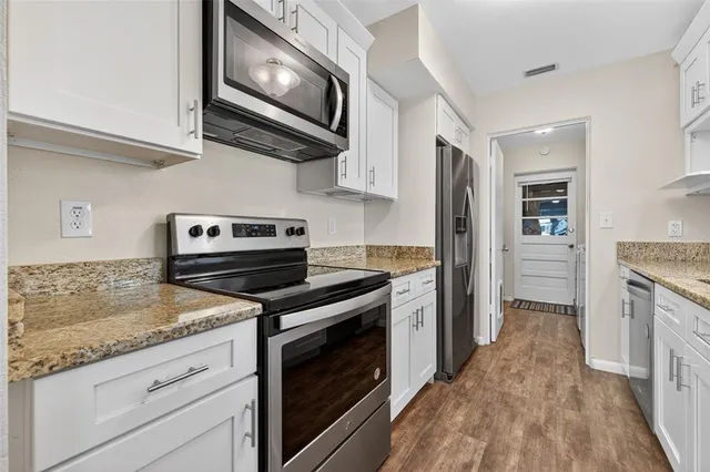 a kitchen with a stove microwave and sink
