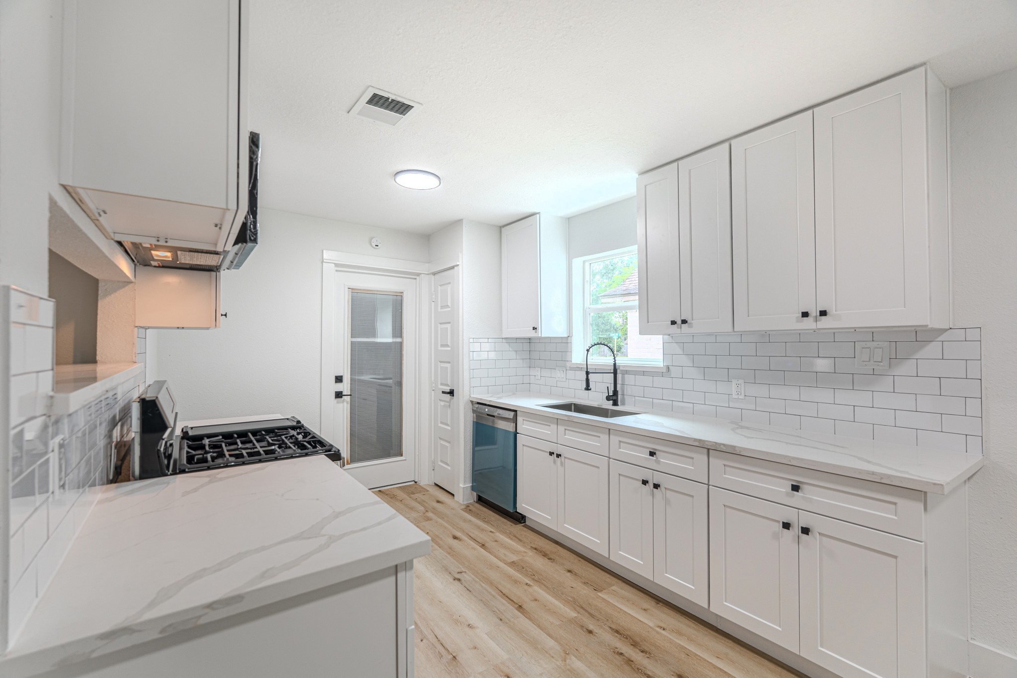 3702 Acorn Way Lane Spring, TX 77389 - Photo 13 of 38 a kitchen with a white cabinets stove and sink