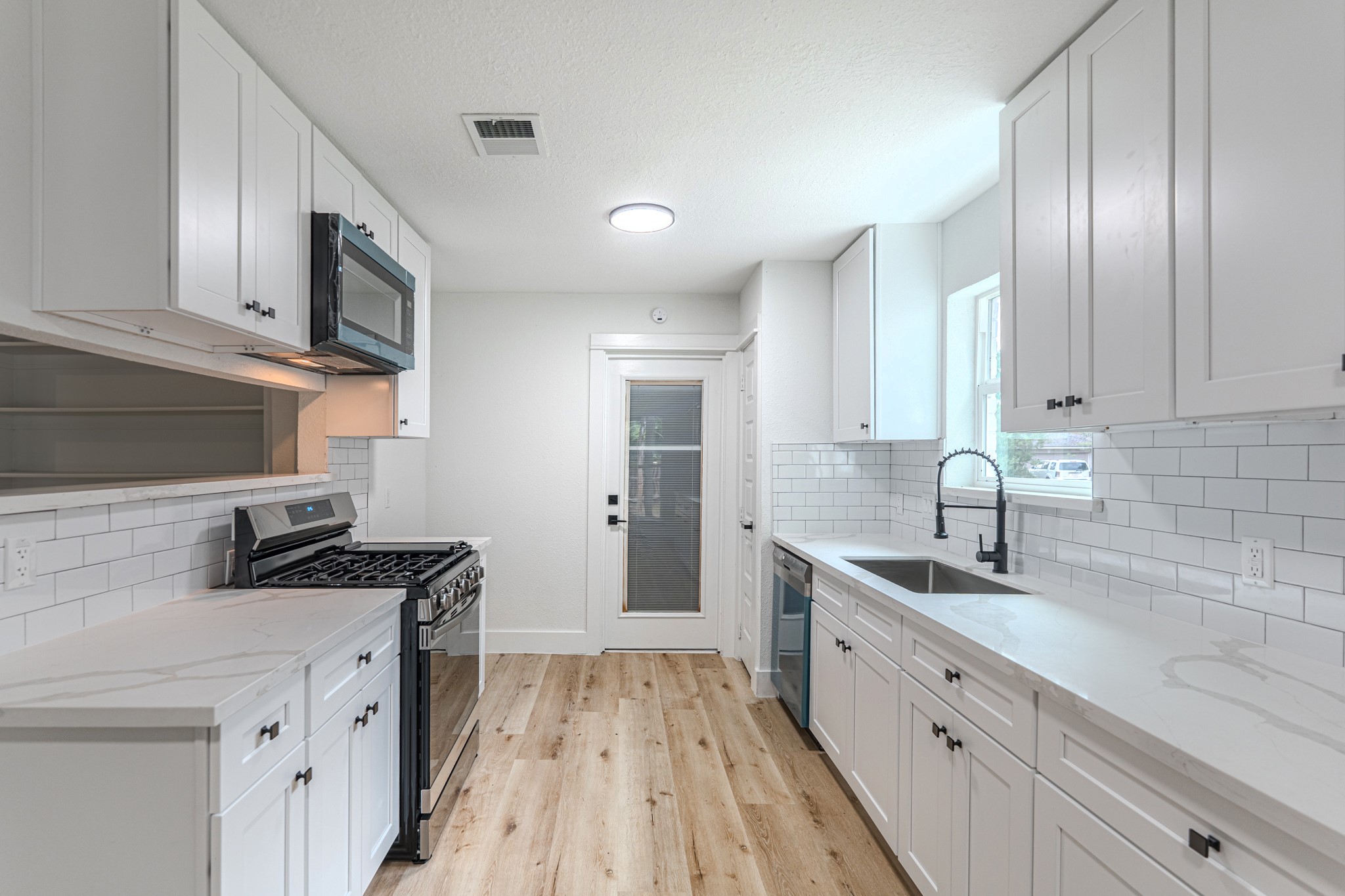 3702 Acorn Way Lane Spring, TX 77389 - Photo 14 of 38 a kitchen with stainless steel appliances granite countertop a sink stove and cabinets