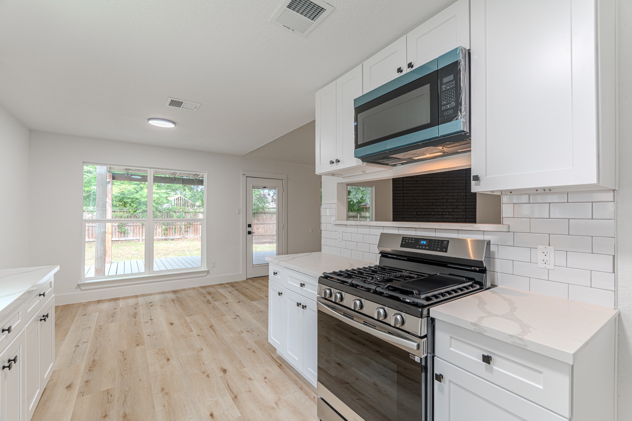3702 Acorn Way Lane Spring, TX 77389 - Photo 16 of 38 a kitchen with a stove and a microwave