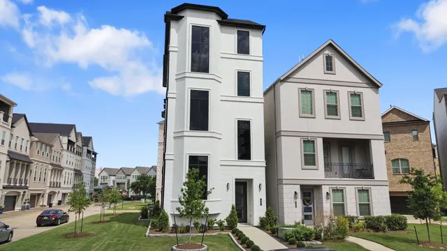 a front view of a residential apartment building with a yard