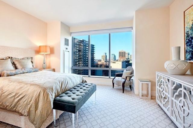 a bedroom with furniture and a large window