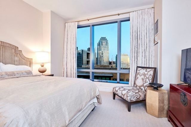 a bedroom with bed and large window