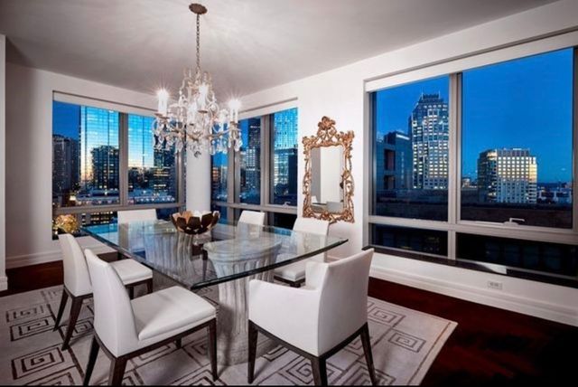 a view of a dining room with furniture and chandelier