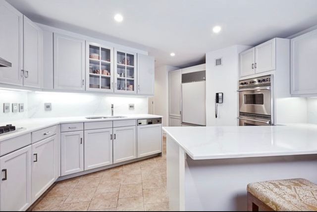 a kitchen with a sink stove and cabinets