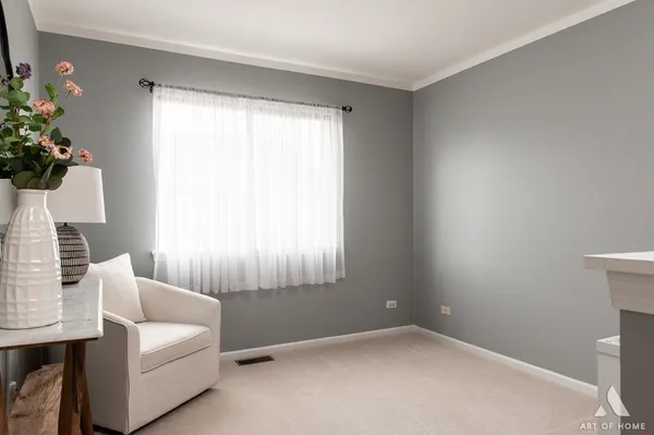 a living room with furniture and flowers