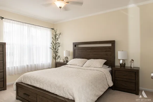 a bedroom with a bed and a chandelier