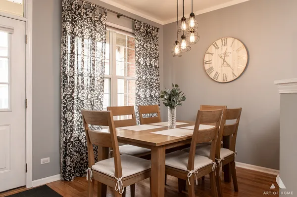 a view of a dining room with furniture chandelier and wooden floor