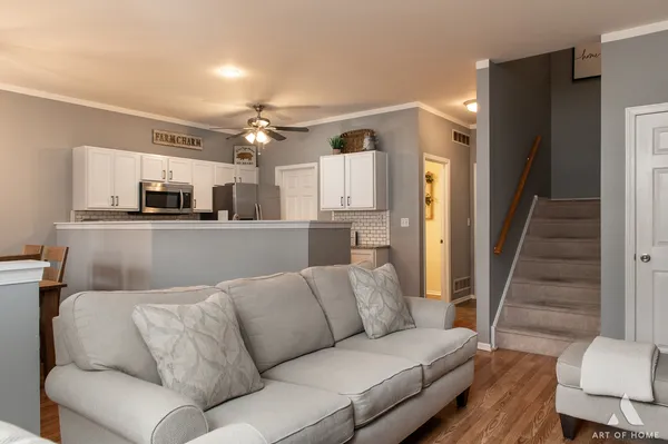 a living room with furniture and kitchen view