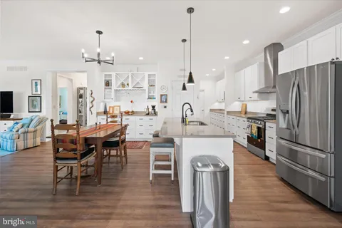 a large kitchen with a table and chairs