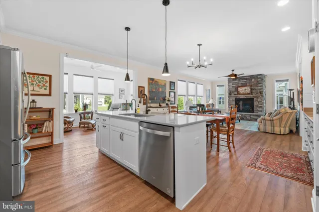 a kitchen with stainless steel appliances granite countertop wooden floors and sink