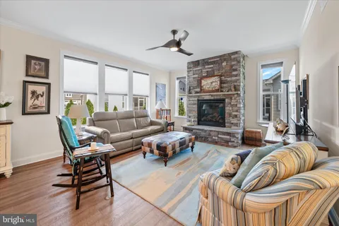 a living room with furniture fireplace and window