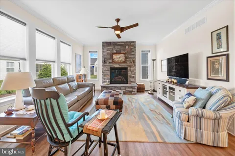 a living room with fireplace furniture and a flat screen tv