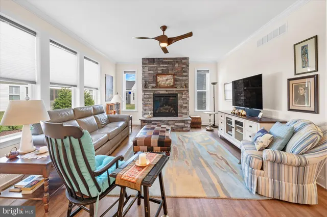a living room with fireplace furniture and a flat screen tv