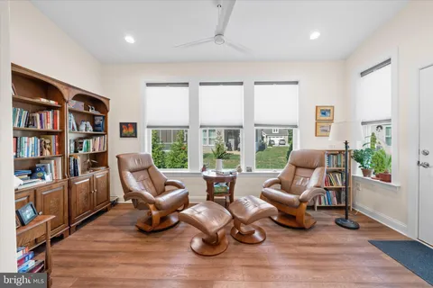 a living room with furniture and a book shelf