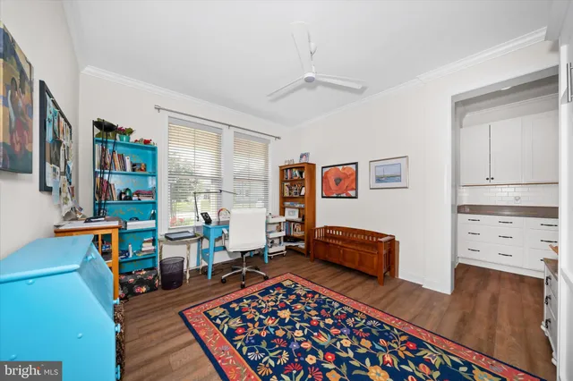 a living room with furniture and a dresser