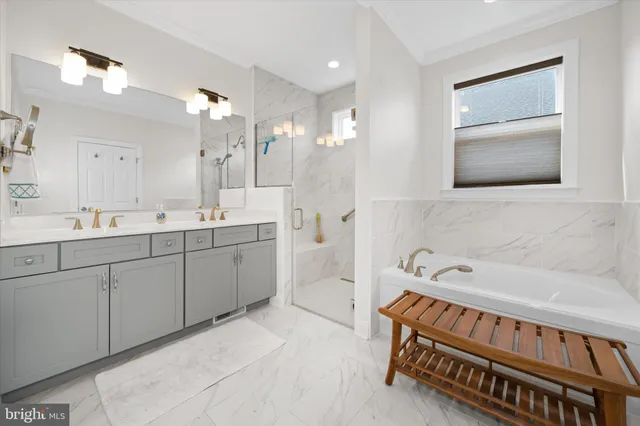 a spacious bathroom with a double vanity sink a mirror and a bathtub