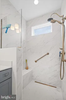 a bathroom with a shower and a sink
