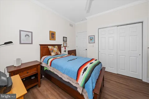a bedroom with a bed and wooden floor
