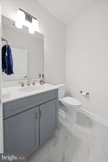 a bathroom with a sink a toilet and mirror