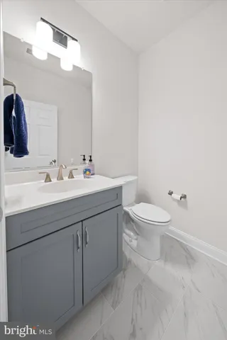 a bathroom with a sink a toilet and mirror