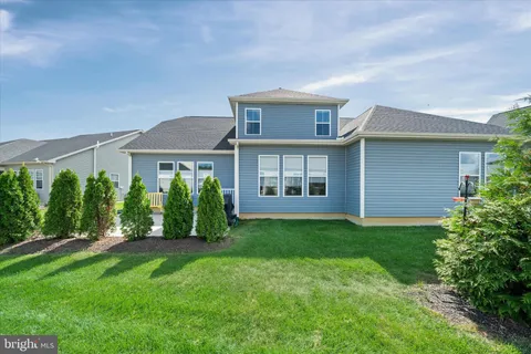 a view of a house with a yard and plants