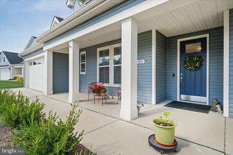 a front view of a house with outdoor seating