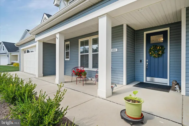 a front view of a house with outdoor seating