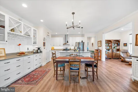 a large kitchen with a table and chairs