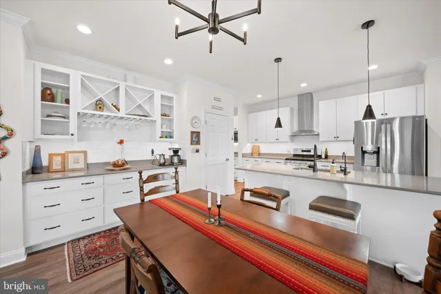 a kitchen with stainless steel appliances granite countertop a sink refrigerator and cabinets