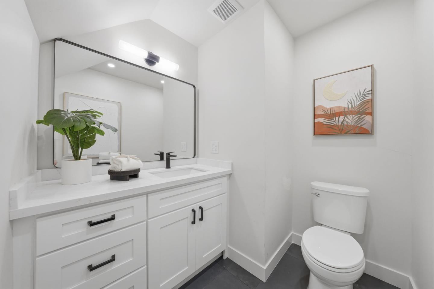 409 Puerto Place Hayward, CA 94541 - Photo 38 of 54 a bathroom with a toilet sink and mirror