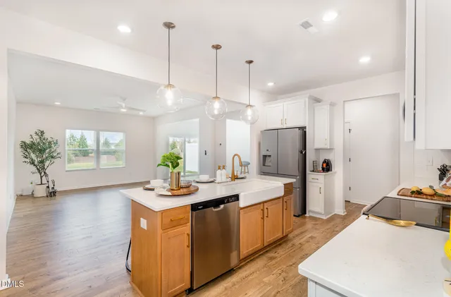 a view of a livingroom with furniture and a potted plant