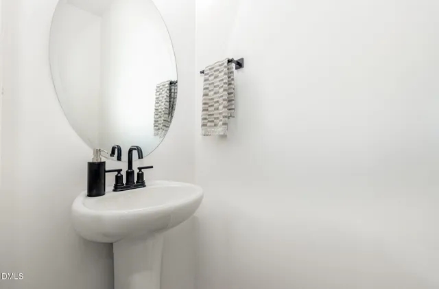 a kitchen with stainless steel appliances granite countertop a sink a stove and a wooden floors